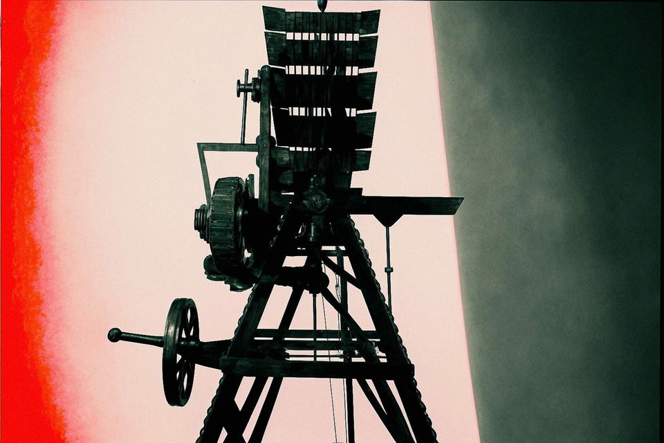 Vintage camera obscura apparatus in dark teal and coral, stark graphic lighting and high contrast