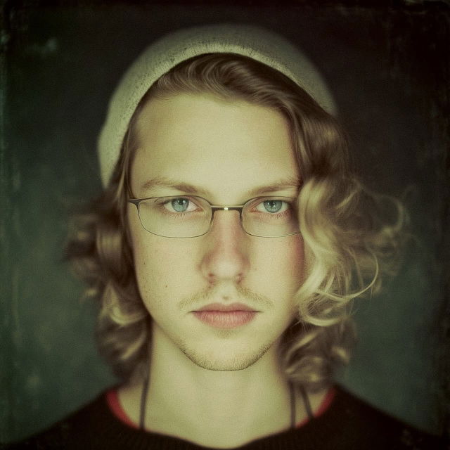 Close-up portrait of a bespectacled person with wavy hair, muted green palette and soft light, Midjourney V4