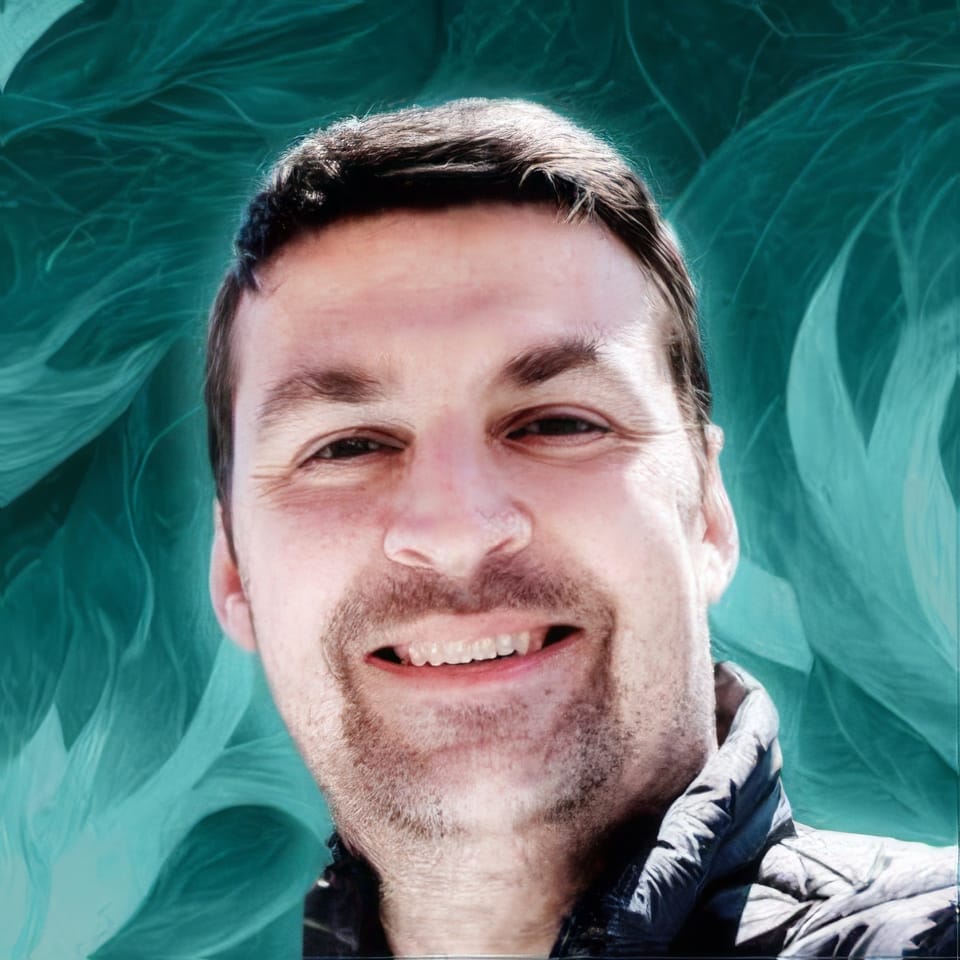 Smiling man in a close-up portrait with teal painterly textures and cool lighting