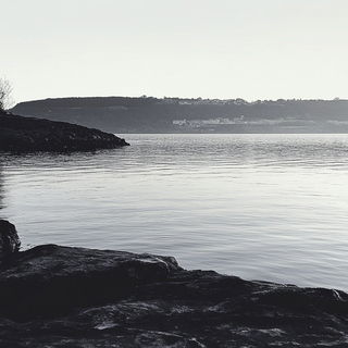 Feathergrotesque style, Midjourney V6.1: realistic landscape photograph of quiet dawn